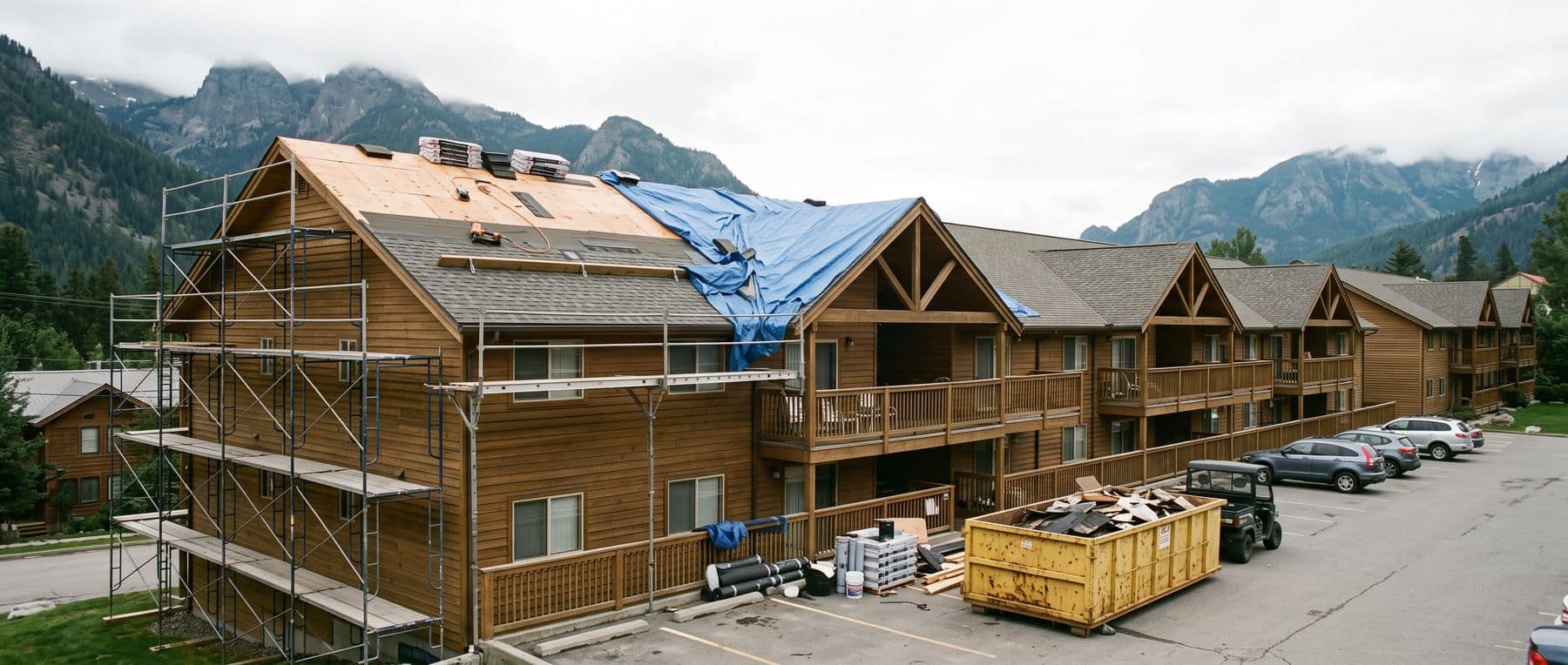 Canmore condo fees at work: scaffolding and a roof replacement underway on a mountain-town condominium