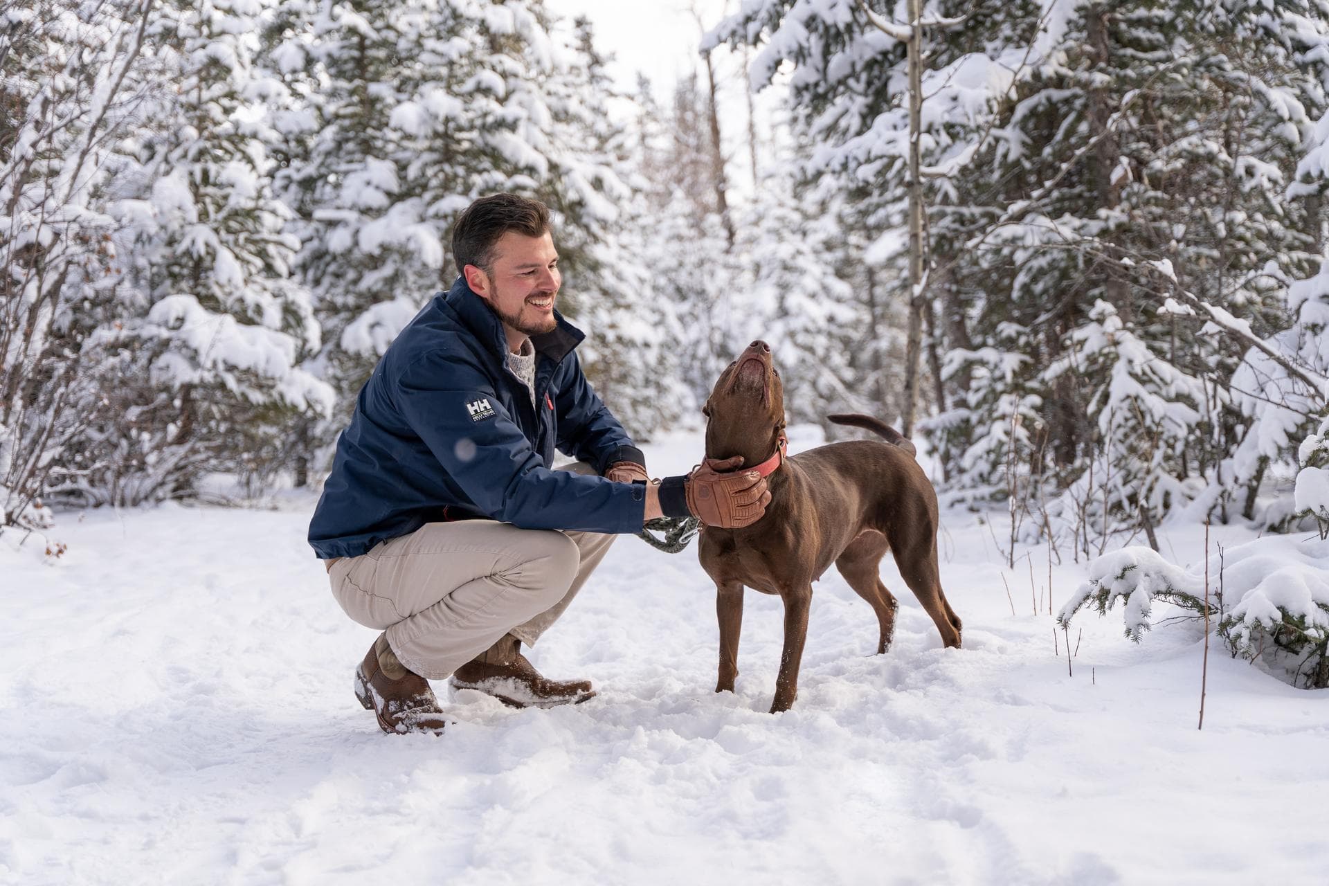 Canmore real estate agent Cory Hand with his rescue dog Jenny on a winter trail near Canmore