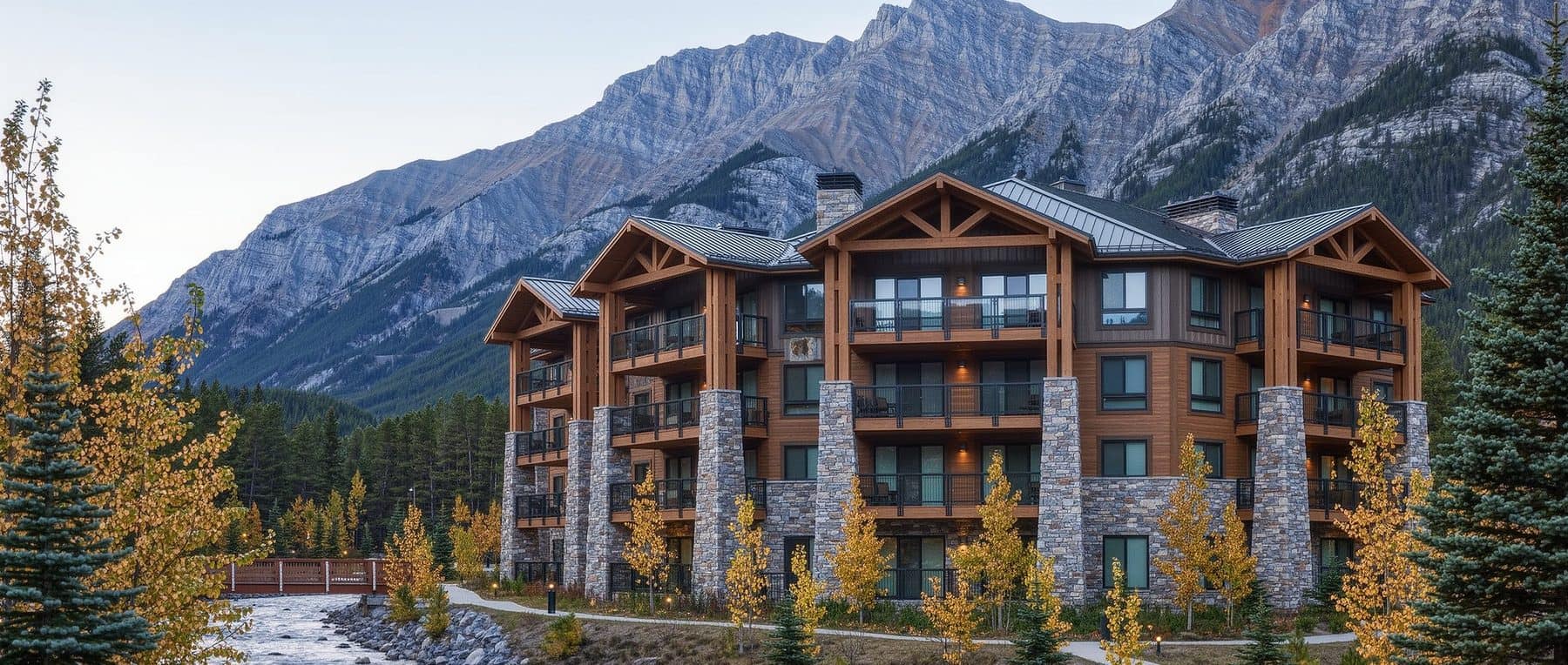 Creekstone Mountain Lodge Canmore: a Spring Creek lodge building beside the creek on an autumn afternoon